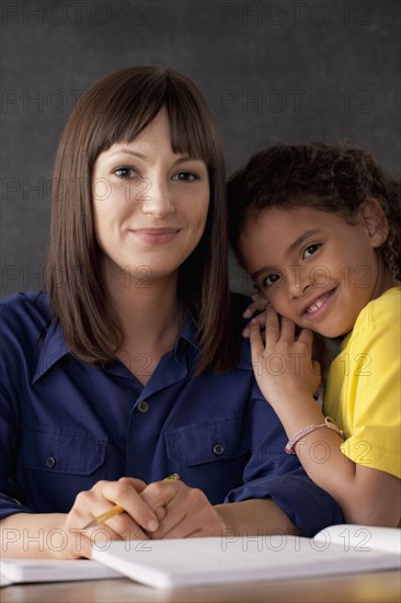 Teacher with smiling schoolgirl. 
Photo : Rob Lewine