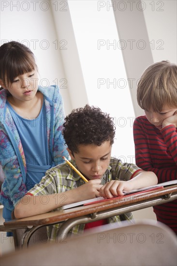 Three children (6-7, 8-9) at school. 
Photo : Rob Lewine