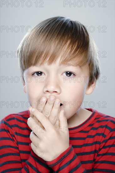 Portrait of boy (6-7), studio shot. 
Photo: Rob Lewine