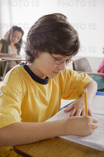 Portrait of schoolboy (10-11) writing. 
Photo : Rob Lewine