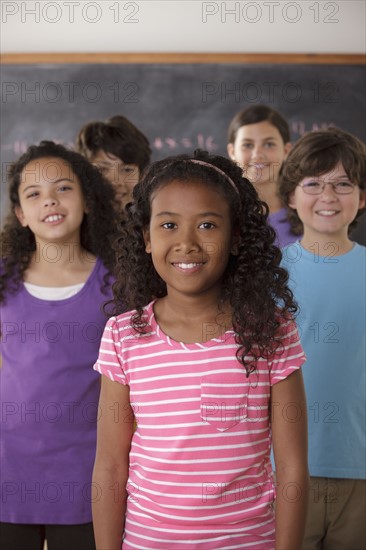 Portrait of pupils (10-11, 12-13) with blackboard in background. 
Photo : Rob Lewine