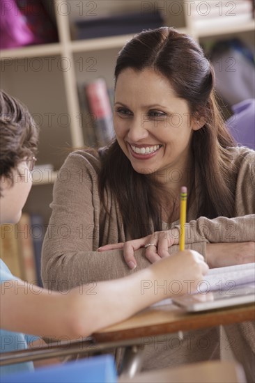 Teacher assisting schoolboy (10-11). 
Photo : Rob Lewine