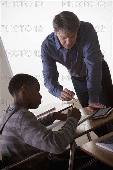 Teenage boy (14-15) with teacher at school. 
Photo : Rob Lewine