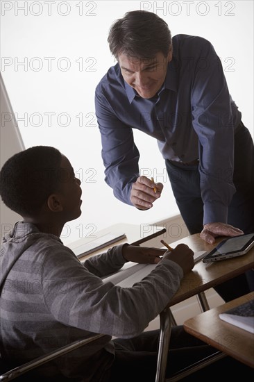Teenage boy (14-15) with teacher at school. 
Photo: Rob Lewine