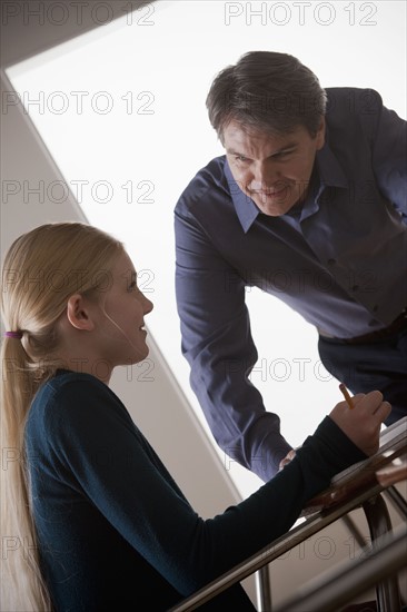 Teenage girl (14-15) with teacher at school. 
Photo : Rob Lewine