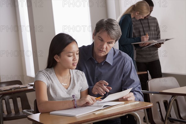 Teacher with teenage students (14-15) at school. 
Photo : Rob Lewine