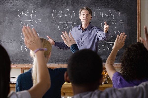 Teacher with teenage students (14-15,16-17) at school. 
Photo : Rob Lewine