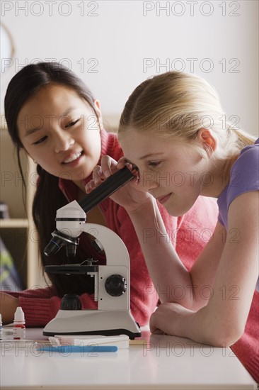 Teenage girls (14-15) working with microscope. 
Photo : Rob Lewine