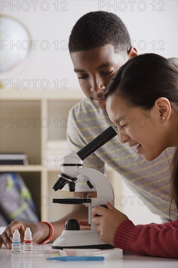 Teenage students (14-15) working with microscope. 
Photo: Rob Lewine