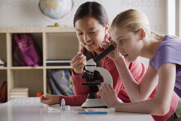 Teenage girls (14-15) working with microscope. 
Photo : Rob Lewine