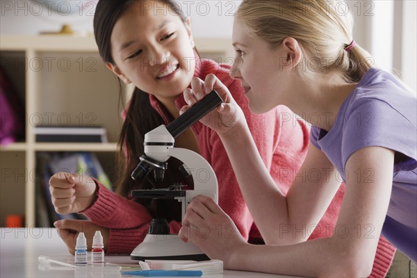 Teenage girls (14-15) working with microscope. 
Photo: Rob Lewine