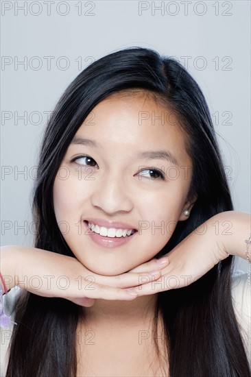 Portrait of teenage girl (14-15), studio shot. 
Photo: Rob Lewine