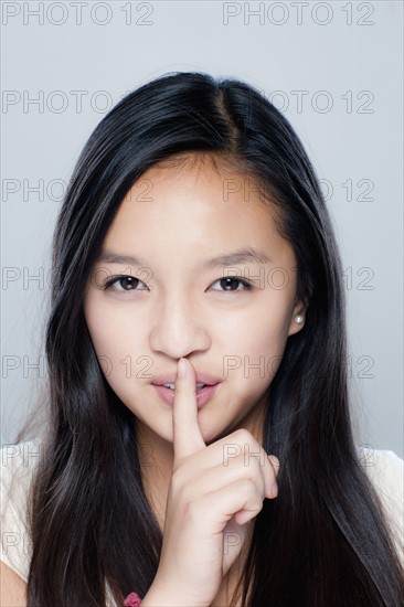 Portrait of teenage girl (14-15), studio shot. 
Photo: Rob Lewine