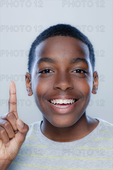 Portrait of teenage boy (14-15), studio shot. 
Photo: Rob Lewine