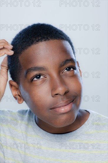 Portrait of teenage boy (14-15), studio shot. 
Photo: Rob Lewine