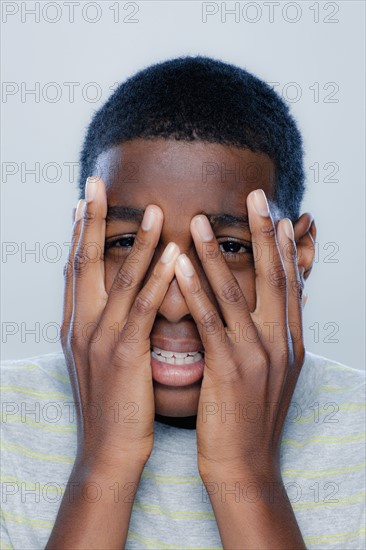 Portrait of teenage boy (14-15), studio shot. 
Photo: Rob Lewine