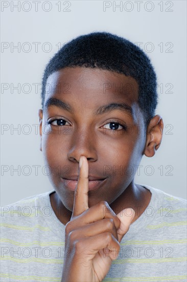 Portrait of teenage boy (14-15), studio shot. 
Photo: Rob Lewine