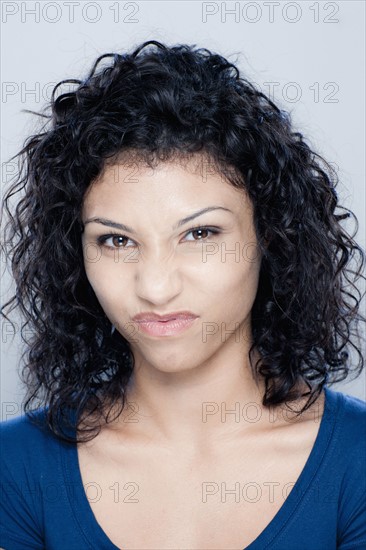 Portrait of teenage girl (16-17), studio shot. 
Photo: Rob Lewine