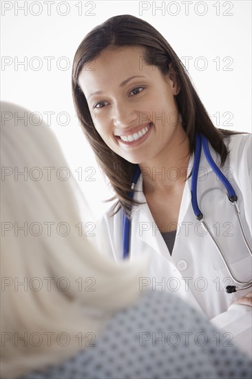 Young doctor talking with senior patient. 
Photo : Rob Lewine