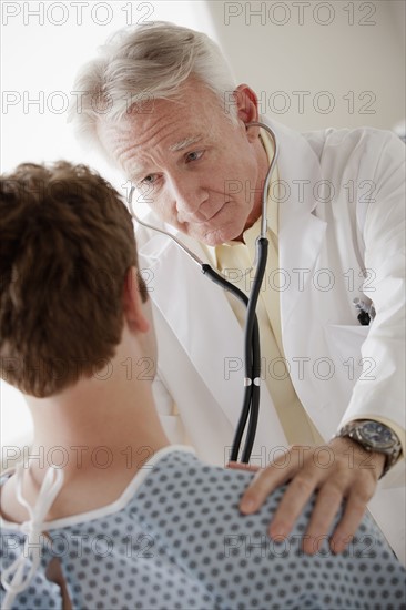 Senior doctor examining patient. 
Photo : Rob Lewine