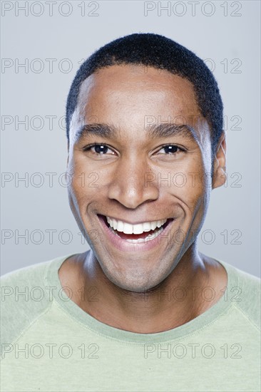 Portrait of smiling young man, studio shot. 
Photo: Rob Lewine