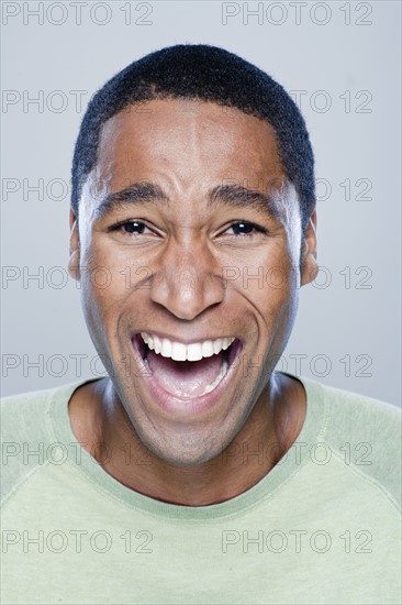 Portrait of laughing young man, studio shot. 
Photo: Rob Lewine
