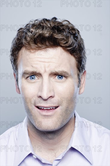 Portrait of surprised mid adult man, studio shot. 
Photo : Rob Lewine