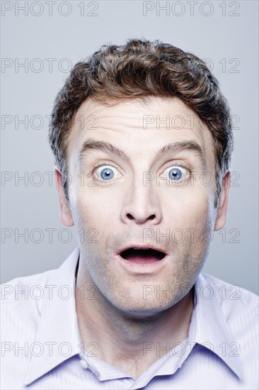 Portrait of surprised mid adult man, studio shot. 
Photo : Rob Lewine