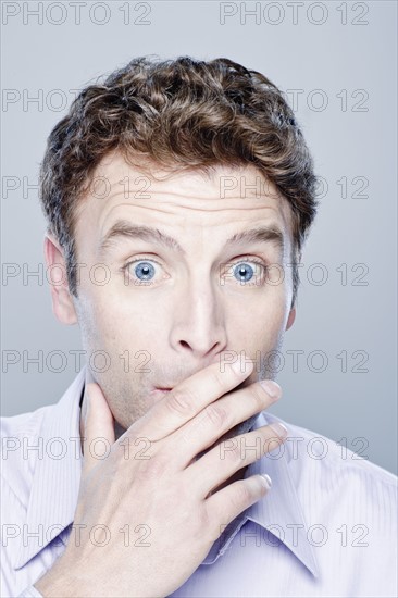 Portrait of surprised mid adult man, studio shot. 
Photo : Rob Lewine