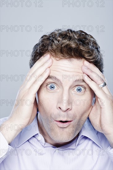 Portrait of surprised mid adult man, studio shot. 
Photo : Rob Lewine