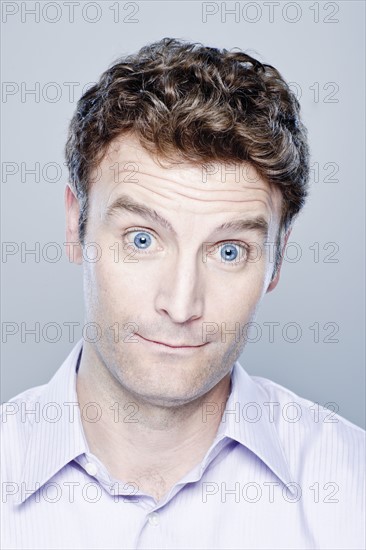 Portrait of surprised mid adult man, studio shot. 
Photo : Rob Lewine