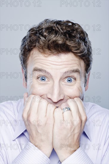 Portrait of worried mid adult man, studio shot. 
Photo : Rob Lewine