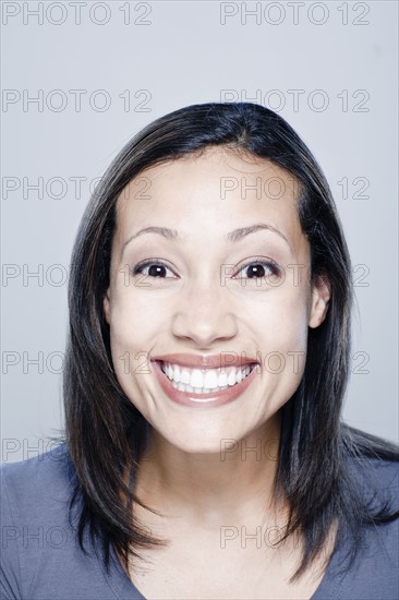 Portrait of happy young woman, studio shot. 
Photo: Rob Lewine