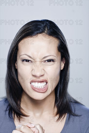 Portrait of angry young woman, studio shot. 
Photo : Rob Lewine