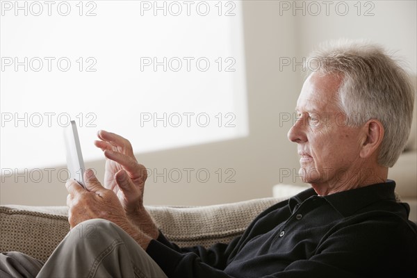 Senior man using digital tablet. 
Photo: Rob Lewine
