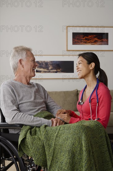 Young female nurse taking care of senior man. 
Photo : Rob Lewine