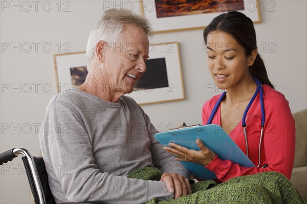 Young female nurse taking care of senior man. 
Photo : Rob Lewine