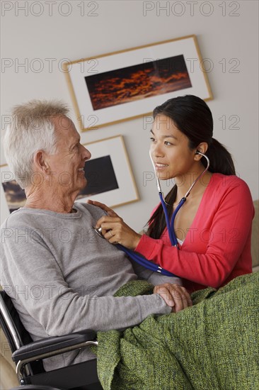 Young female nurse taking care of senior man. 
Photo : Rob Lewine