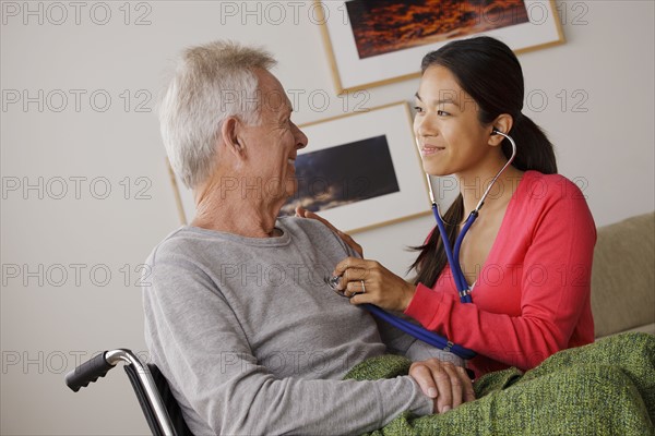 Young female nurse taking care of senior man. 
Photo : Rob Lewine