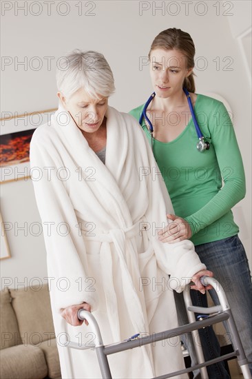 Young female nurse taking care of senior woman with walker. 
Photo: Rob Lewine