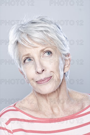 Portrait of thoughtful senior woman, studio shot. 
Photo : Rob Lewine