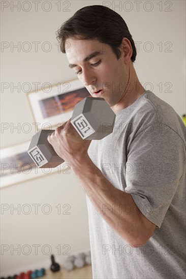 Young man exercising with dumbbell. 
Photo: Rob Lewine