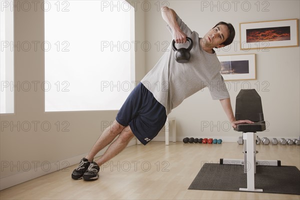 Young man exercising with weight. 
Photo: Rob Lewine