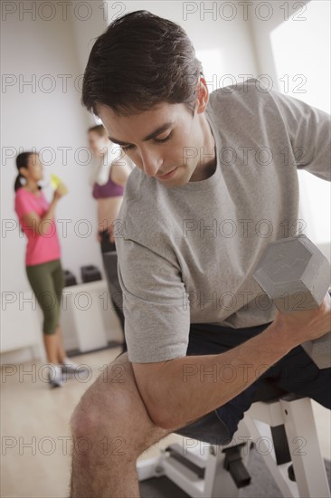 Young man exercising with dumbbell. 
Photo: Rob Lewine