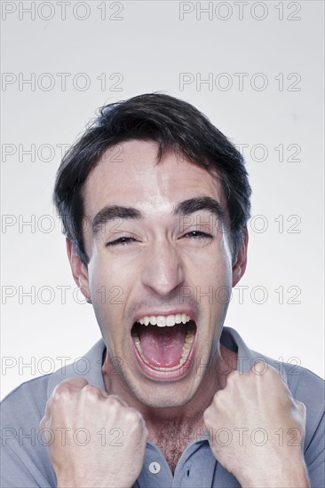 Portrait of excited man, studio shot. 
Photo : Rob Lewine