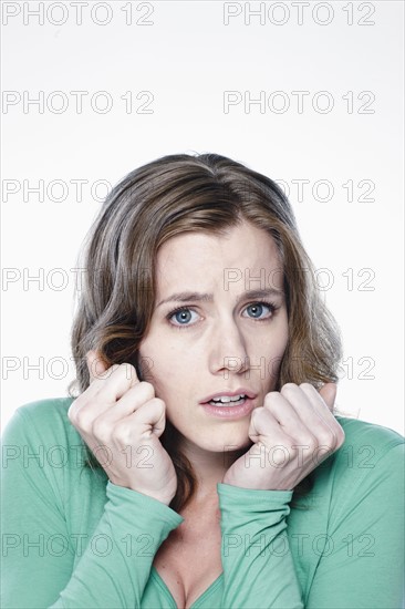 Portrait of worried young woman, studio shot. 
Photo : Rob Lewine