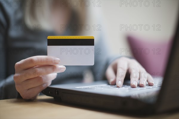 Netherlands, Goirle, Young woman shopping online. 
Photo : Mark de Leeuw