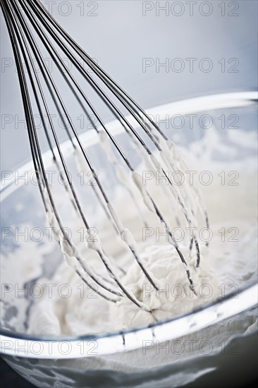 Whisking cream, studio shot. 
Photo : Elena Elisseeva