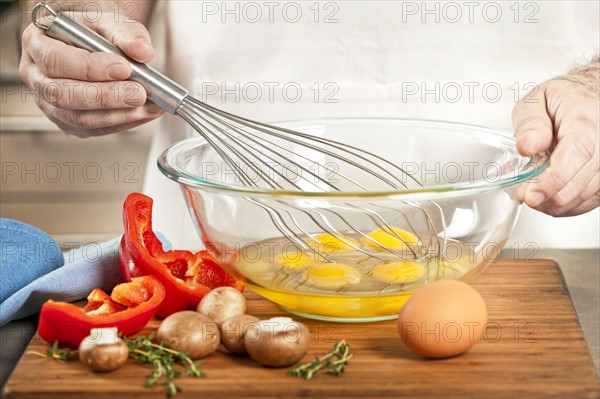 Chef preparing omelet. 
Photo : Elena Elisseeva