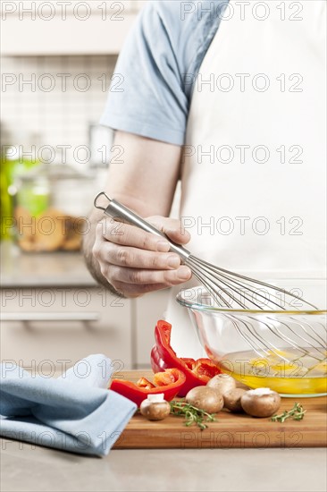 Chef preparing omelet. 
Photo : Elena Elisseeva